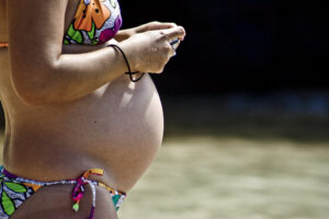 Pregnant woman, representing patients who may need oral surgery care during pregnancy