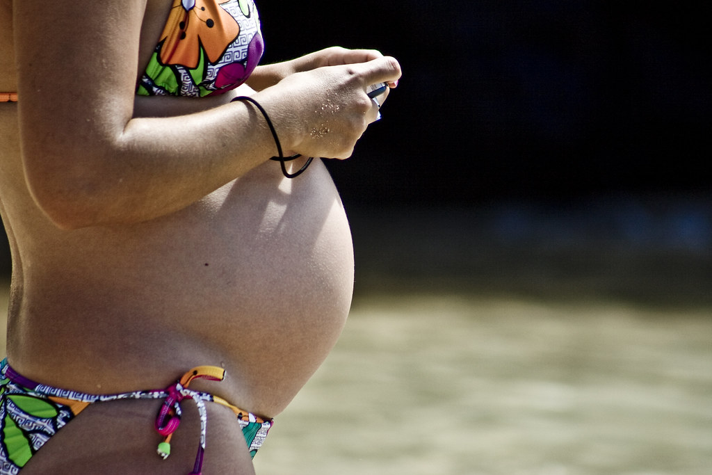 Pregnant woman, representing patients who may need oral surgery care during pregnancy